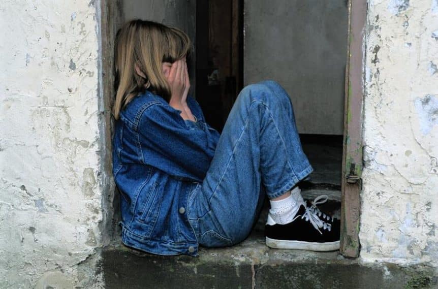 A depressed young girl sitting.